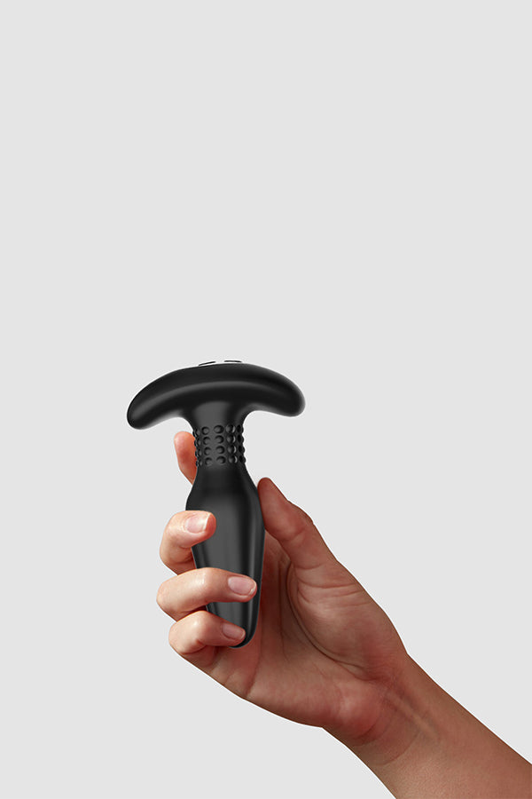Hand holding Onyx against a gray backdrop