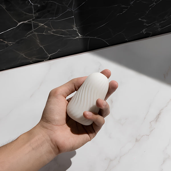 Hand holding Super against a marble surface