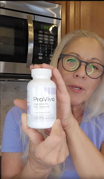 Woman holding a ProViva supplement bottle indoors