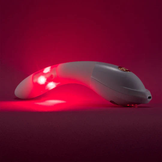 White electronic device with red lights on a pink background