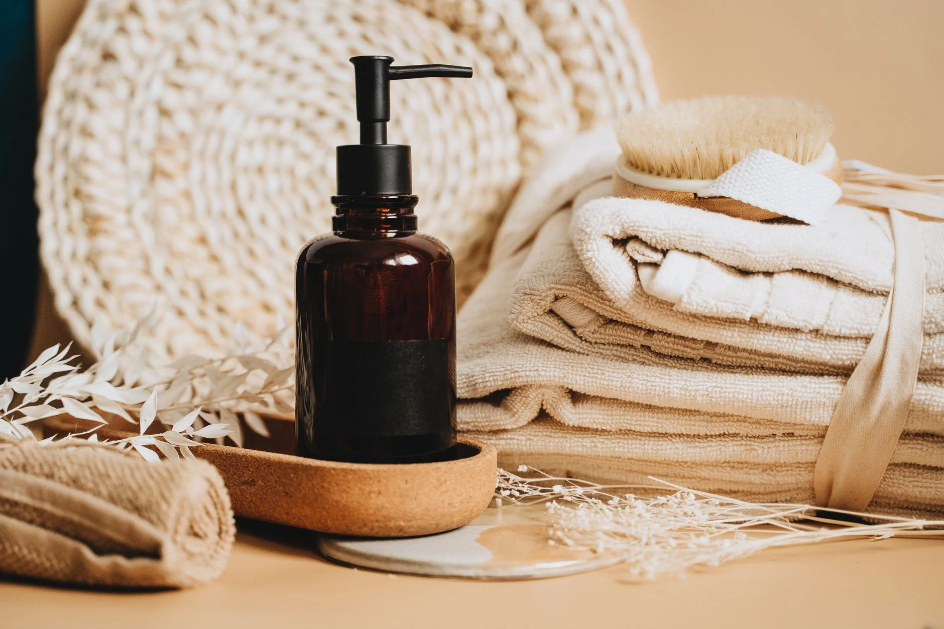Neutral spa towels and pump bottle — cleaning, lube and storage care essentials