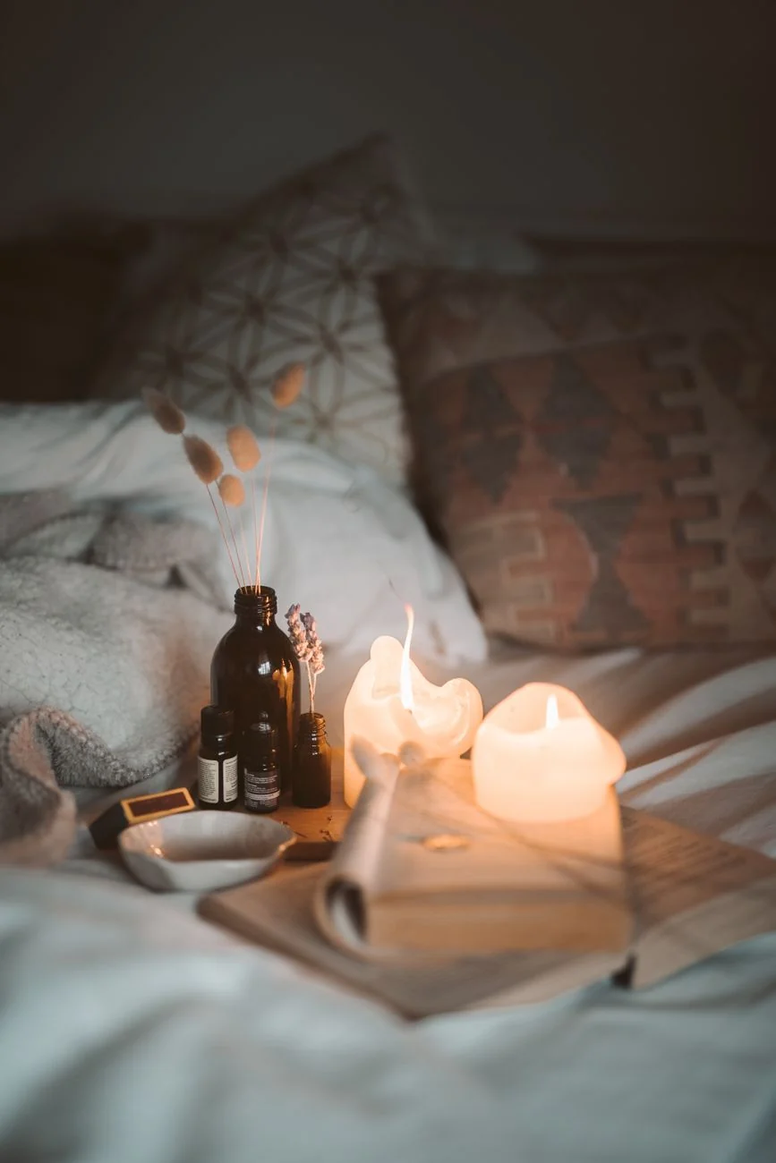 Calm candlelit bedroom setting the mood for a relaxed beginner butt plug safety guide