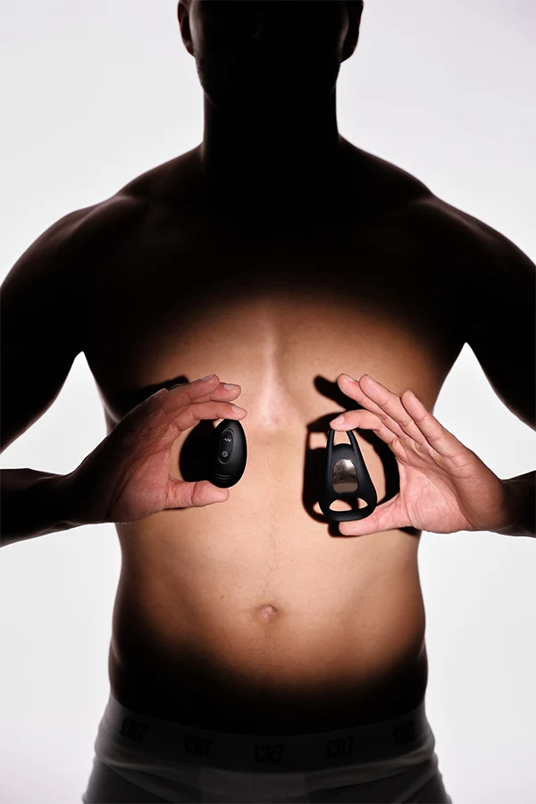 Man holding Lucas 2 over their stomach against a white background