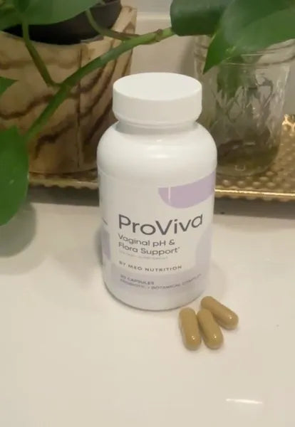 ProViva supplement bottle with capsules on a surface with plants in the background