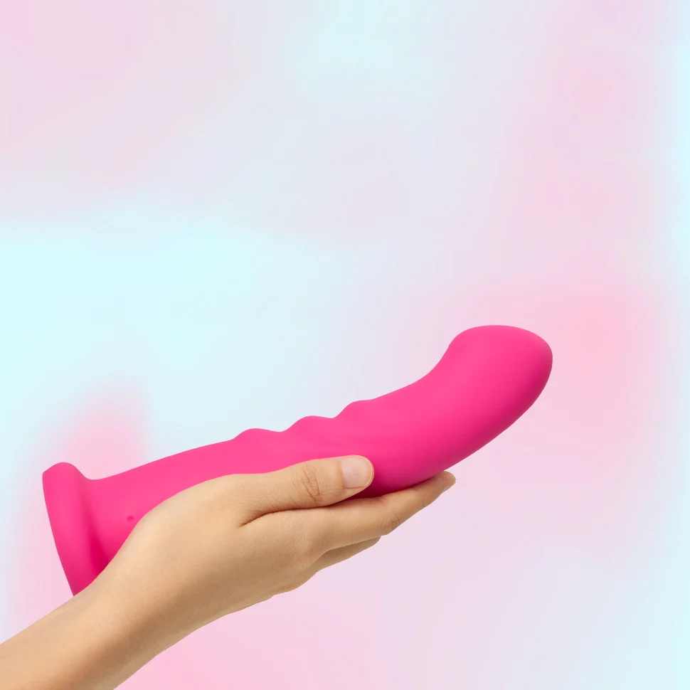 Hand holding Renee against a pink and blue gradient background