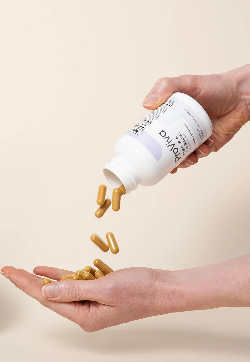 Person pouring supplements from a bottle into their hand