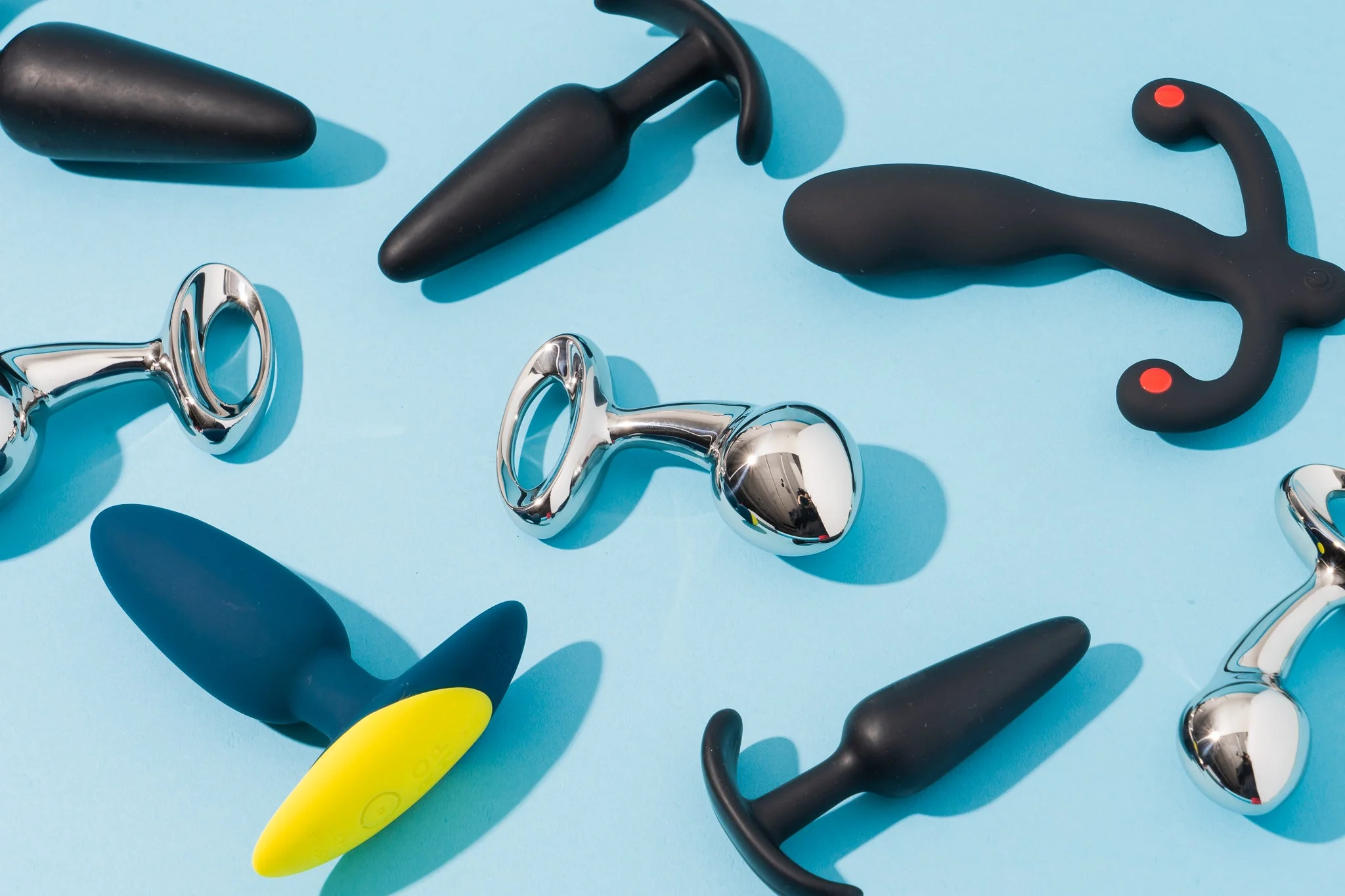 Collection of penis pumps against a blue background