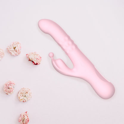 Elizabeth flat lay against a light pink backdrop with flowers